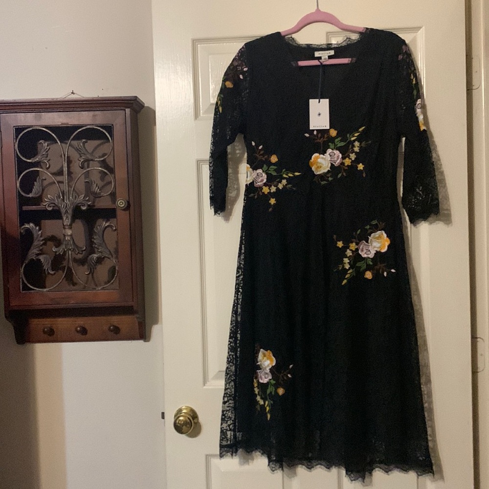Black laced dress with flowers throughout.